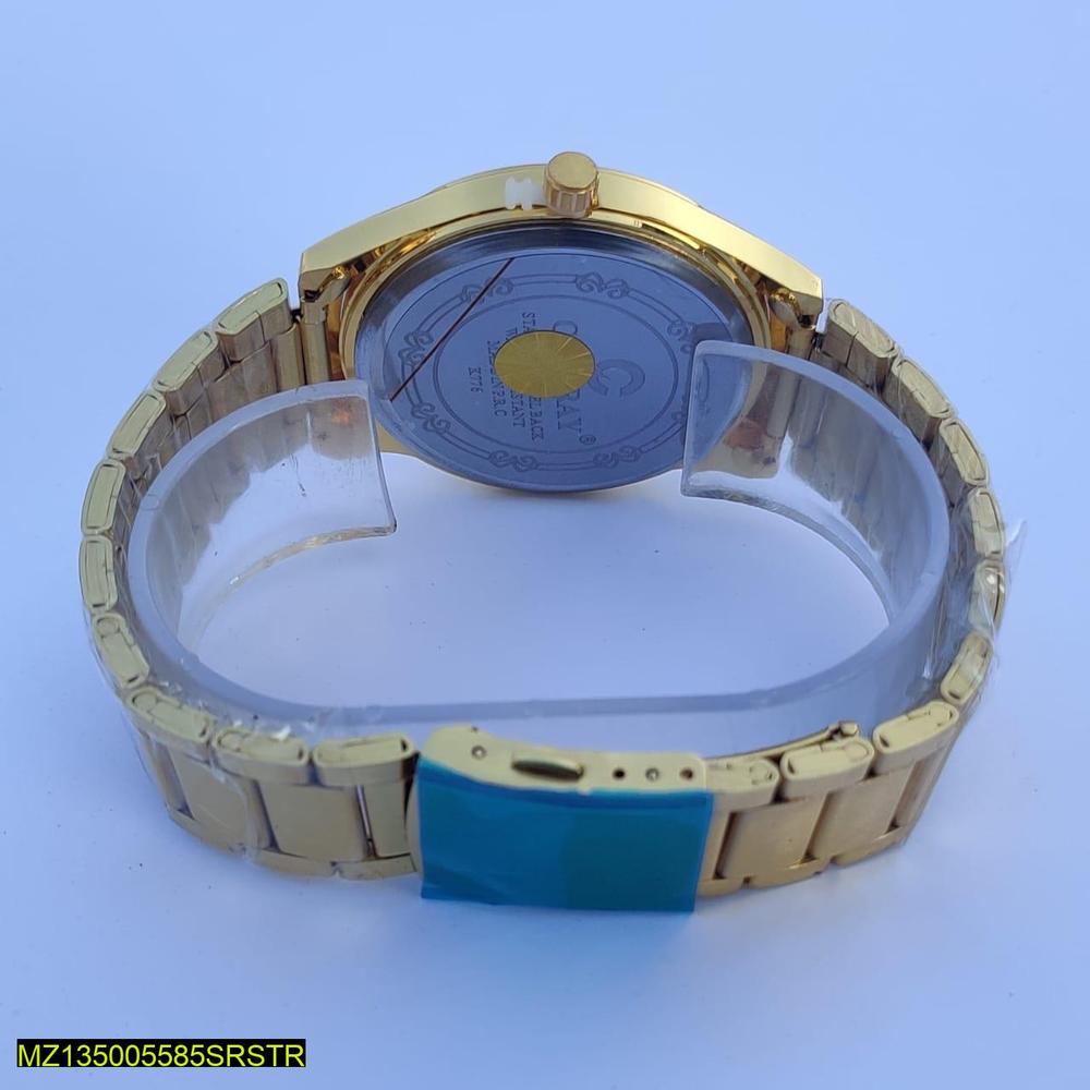 Gold wristwatch with a clear face on a light blue background