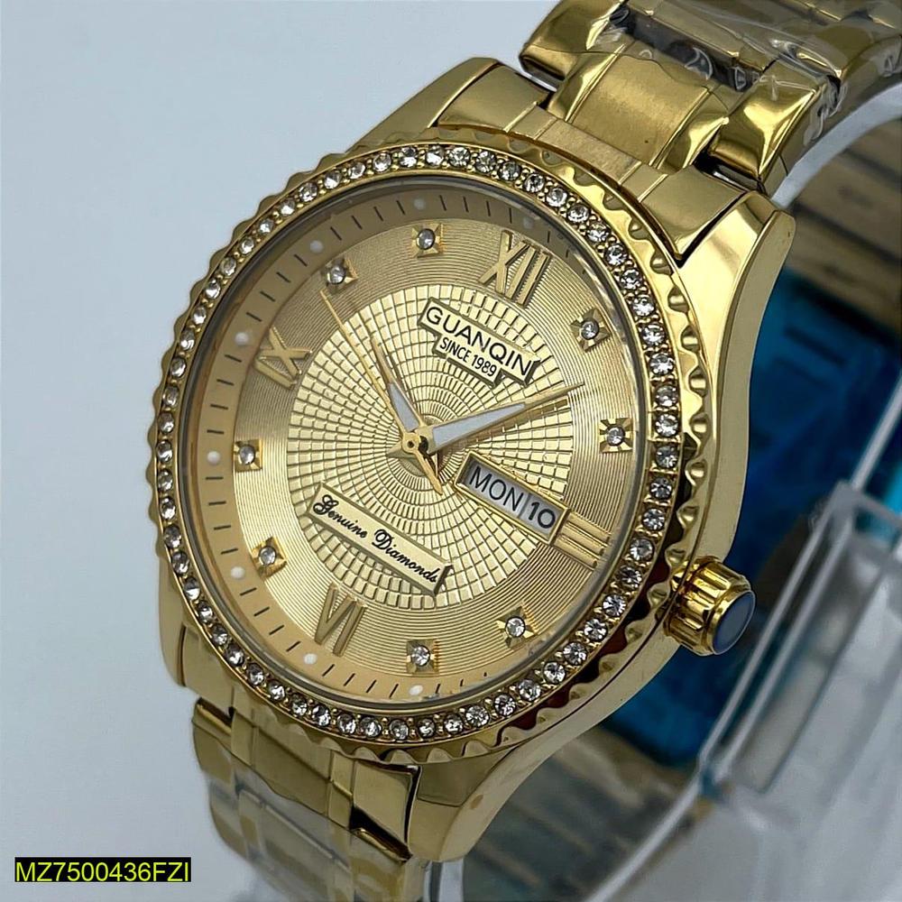 Gold wristwatch with diamond-studded bezel on a light blue background