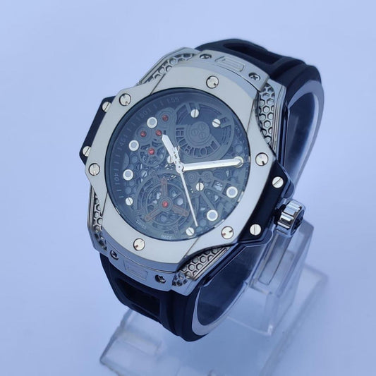 Luxury watch with black strap and silver case on a light blue background