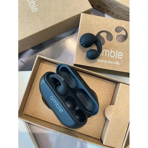 Blue 'ambie' earcuffs in a cardboard box with 'ambie' branding.