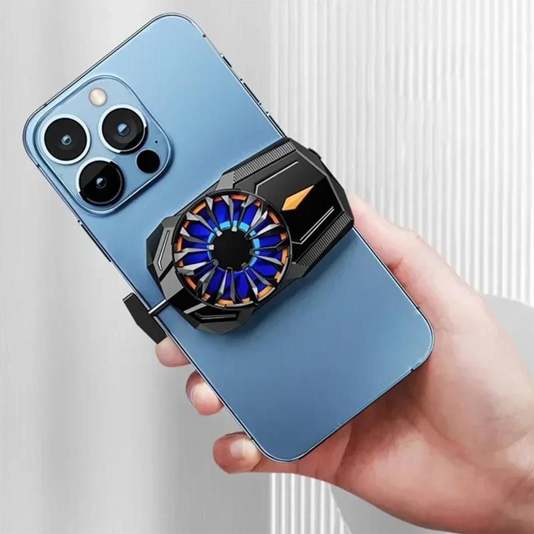 Hand holding a blue smartphone with a cooling device attached. Enjoy Your gaming without heat worries